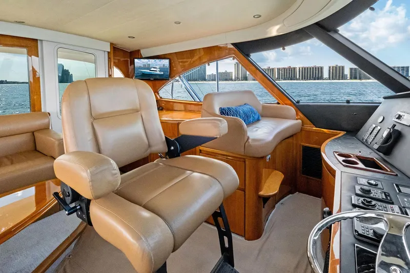 Slide: The Image of Luxurious interior of 2017 Viking 62 Enclosed Bridge yacht with leather seating and ocean view. - 58