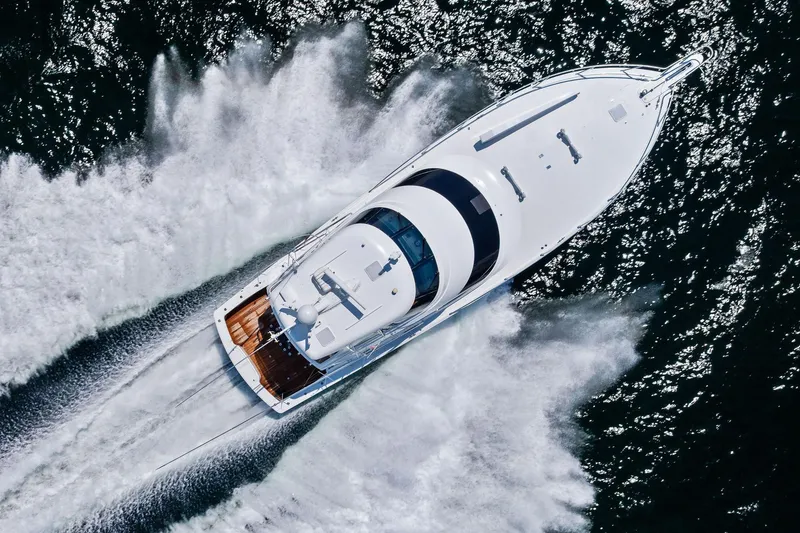 Slide: The Image of Aerial view of 2017 Viking 62 Enclosed Bridge yacht cruising on water. - 66