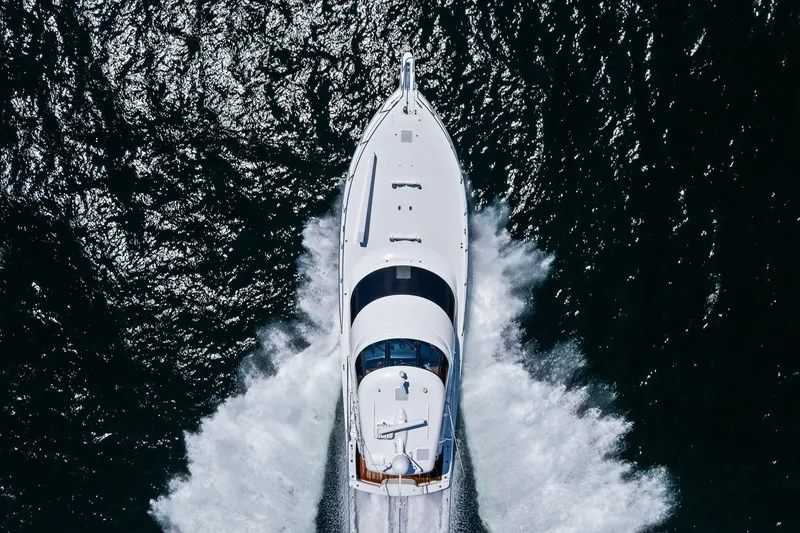 Slide: The Image of Aerial view of 2017 Viking 62 Enclosed Bridge yacht cruising on open water. - 67