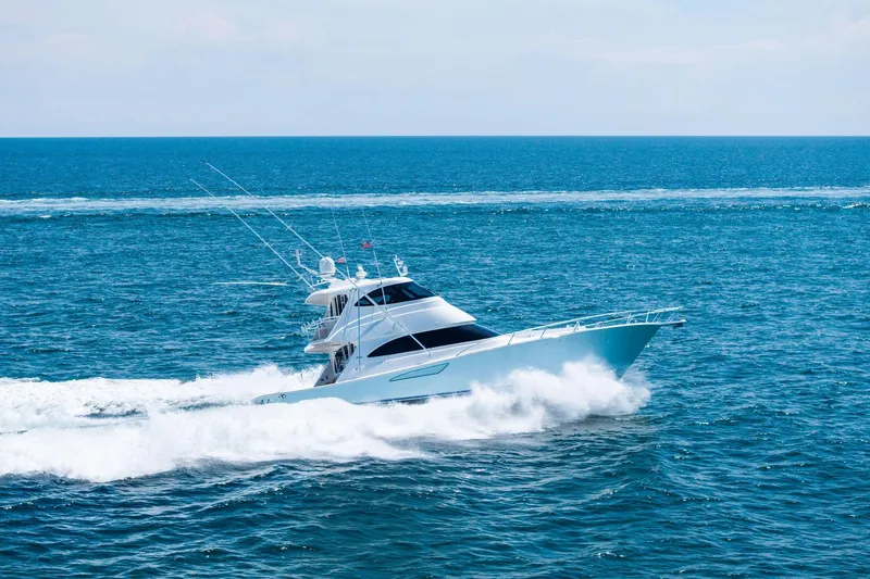 Slide: The Image of 2017 Viking 62 Enclosed Bridge yacht cruising on open ocean waters. - 74