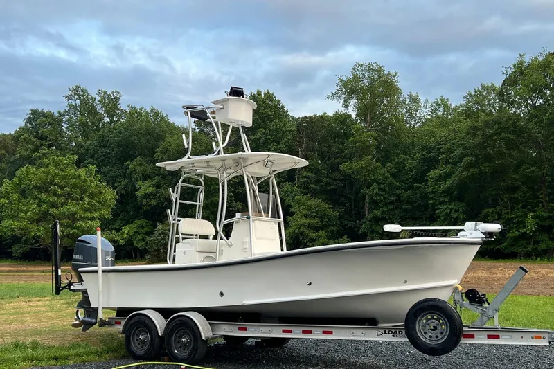 Slide: The Image of 2014 Privateer ROAMER II boat on trailer, surrounded by lush greenery. - 0