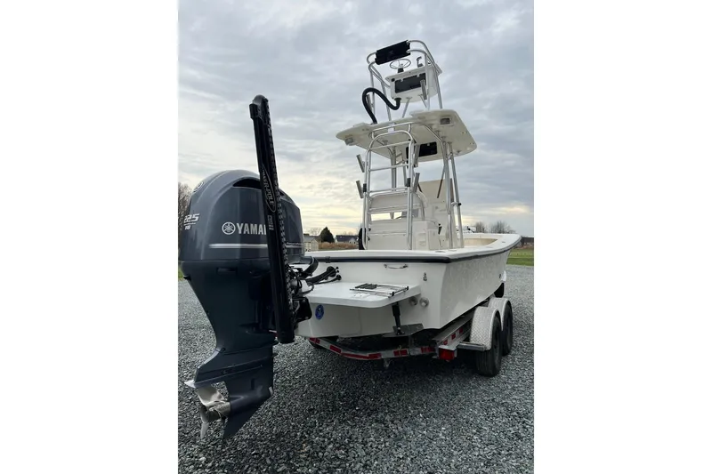 Slide: The Image of 2014 Privateer ROAMER II boat with Yamaha engine on a trailer, under cloudy sky. - 1