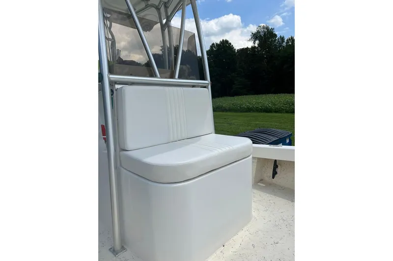 Slide: The Image of 2014 Privateer ROAMER II boat seat with white cushion, outdoors under blue sky. - 6