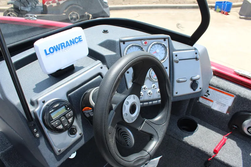 Slide: The Image of 2026 Tracker Super Guide V-16 SC boat interior with gray seats and steering wheel. - 10