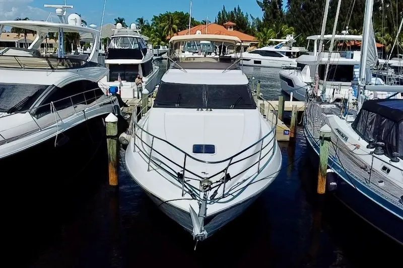 Slide: The Image of 1999 Azimut 58 yacht docked at marina, surrounded by other boats. - 11