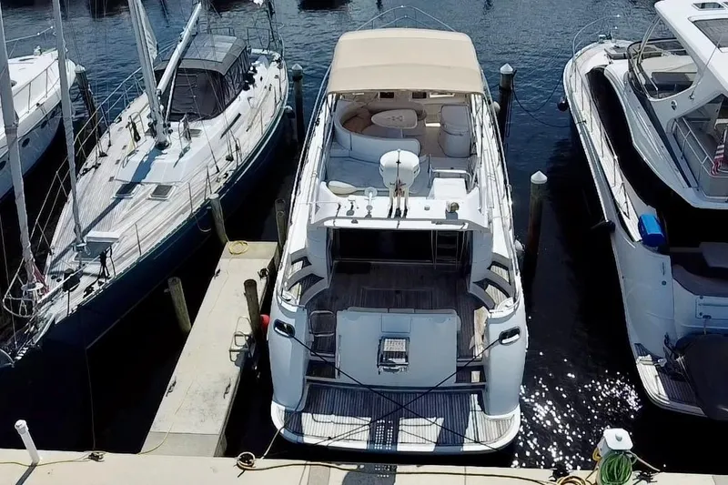 Slide: The Image of 1999 Azimut 58 yacht docked at marina, surrounded by other boats. - 12