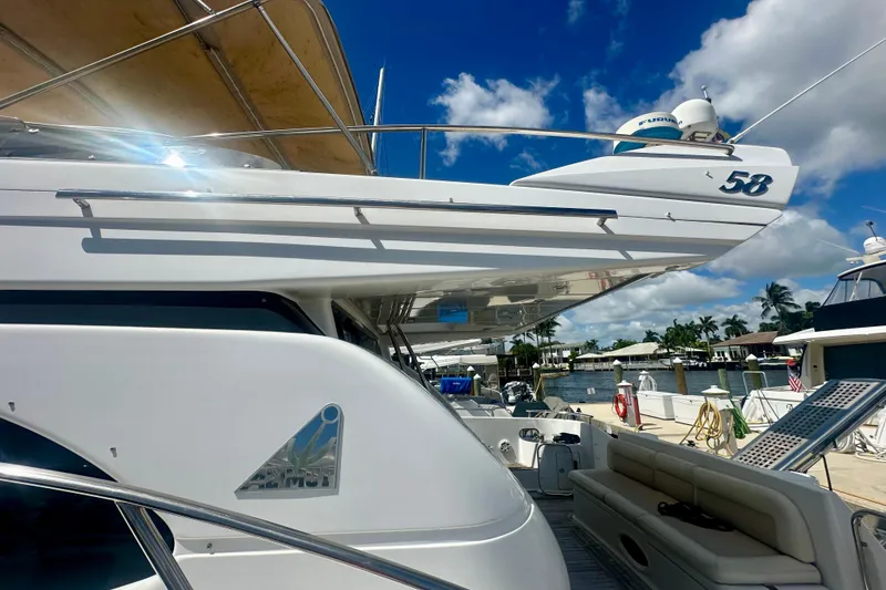 Slide: The Image of Luxurious 1999 Azimut 58 yacht docked under a clear blue sky. - 17