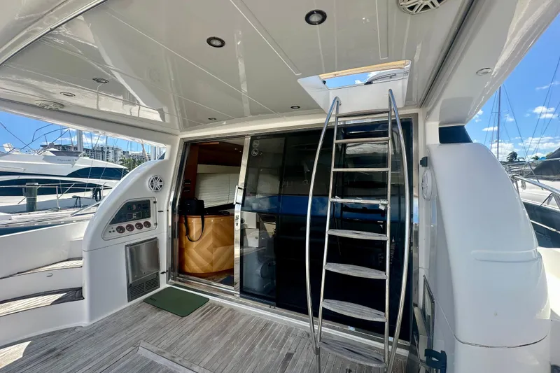 Slide: The Image of 1999 Azimut 58 yacht interior with ladder, sliding door, and control panel. - 18