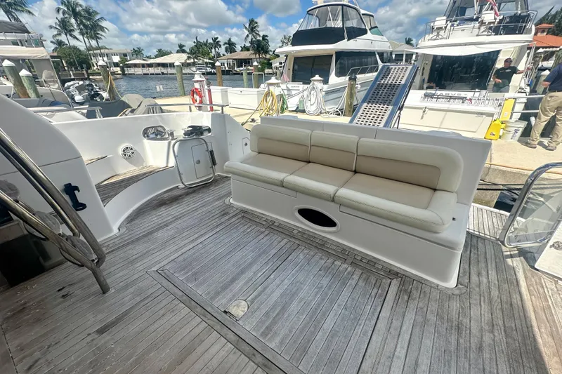 Slide: The Image of Spacious deck of a 1999 Azimut 58 yacht with comfortable seating and marina view. - 21