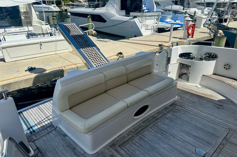Slide: The Image of 1999 Azimut 58 yacht deck with seating and dock view. - 22