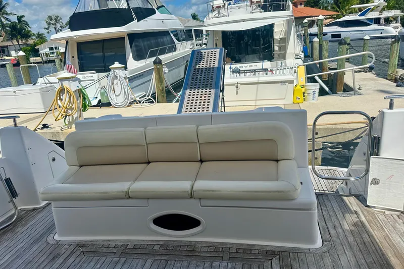 Slide: The Image of Luxury Azimut 58 yacht deck with cushioned seating, docked at marina, 1999 model. - 23