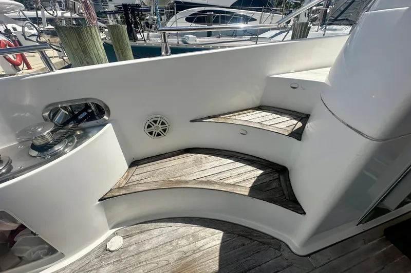 Slide: The Image of Staircase on 1999 Azimut 58 yacht with wooden steps and white railing. - 25