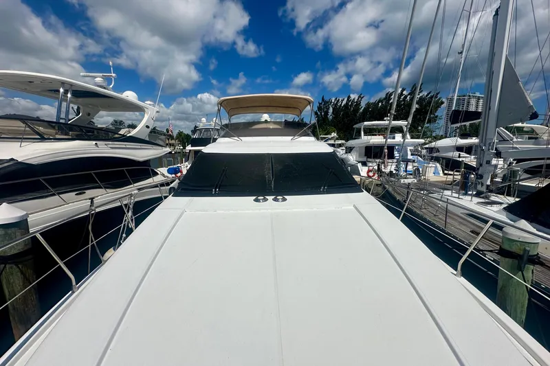 Slide: The Image of 1999 Azimut 58 yacht docked at marina under blue sky. - 31