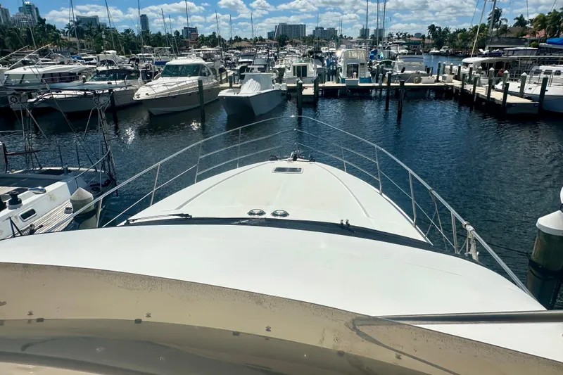 Slide: The Image of 1999 Azimut 58 yacht docked in a marina with surrounding boats. - 33