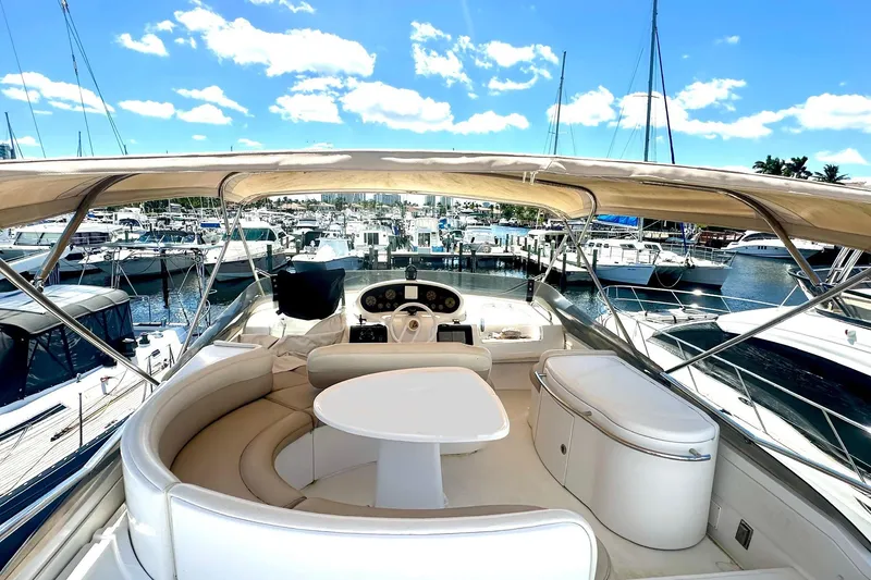 Slide: The Image of 1999 Azimut 58 yacht interior with helm, seating, and marina view. - 42
