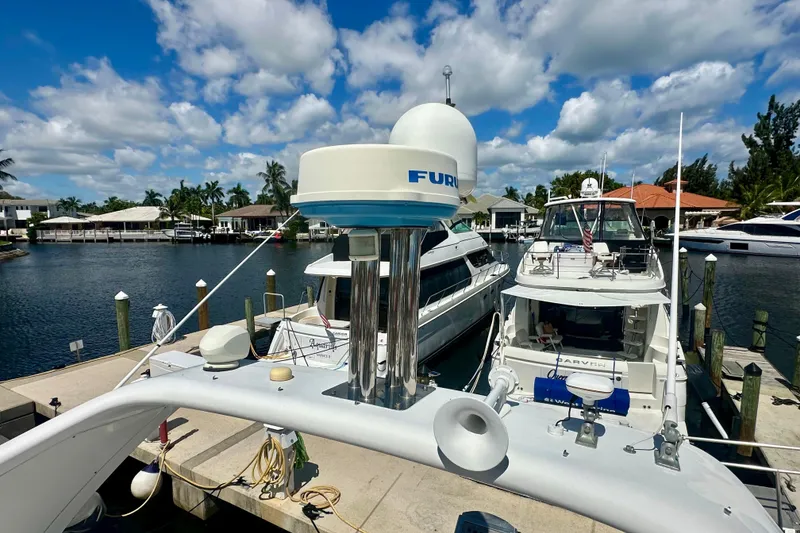 Slide: The Image of 1999 Azimut 58 yacht docked at marina under blue sky and clouds. - 44