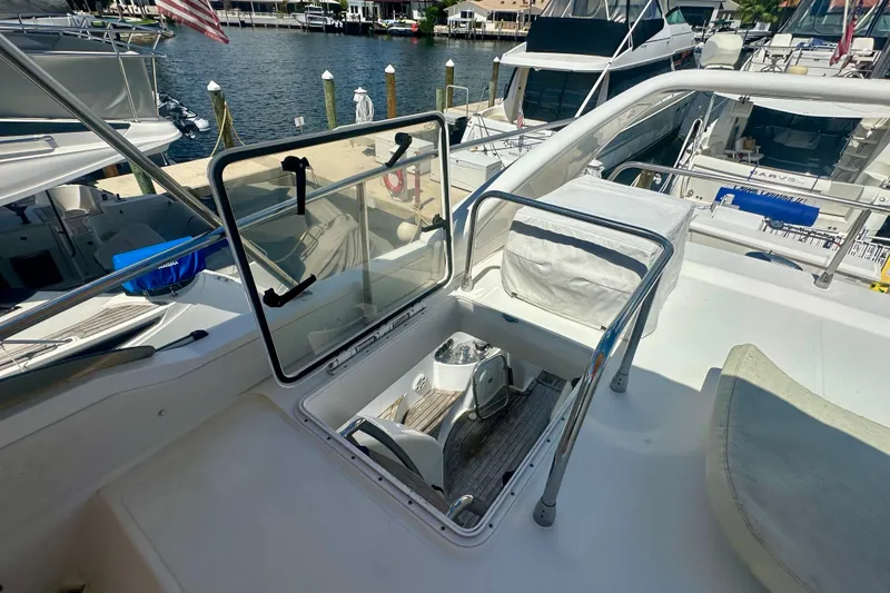 Slide: The Image of 1999 Azimut 58 yacht deck with open hatch, docked at marina. - 45