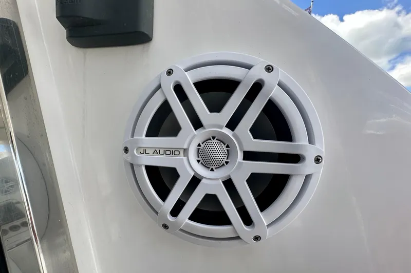 Slide: The Image of JL Audio speaker on 1999 Azimut 58 yacht, white exterior, clear sky background. - 49