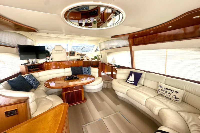 Slide: The Image of Luxurious 1999 Azimut 58 yacht interior with plush seating, elegant wood finishes, and modern amenities. - 51