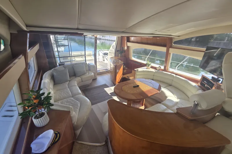Slide: The Image of Luxurious interior of a 1999 Azimut 58 yacht with elegant seating and panoramic windows. - 55