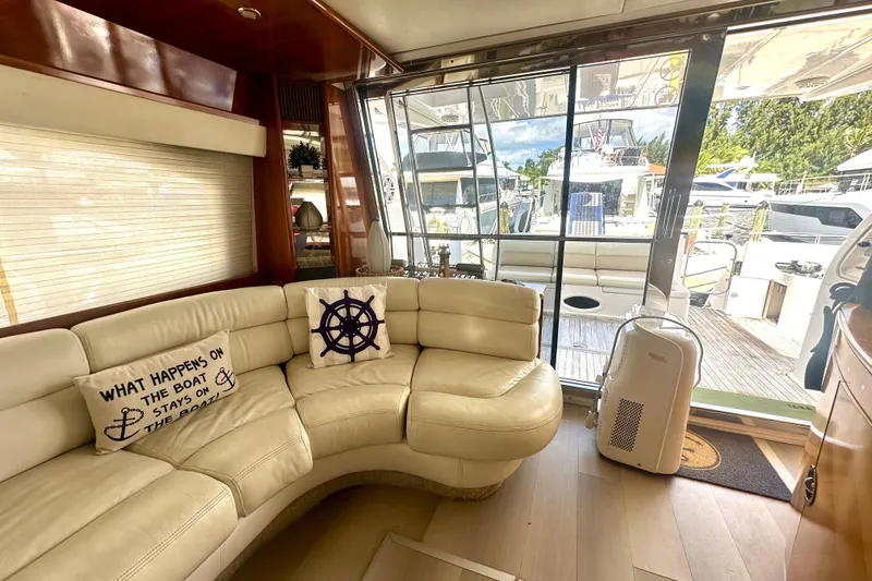 Slide: The Image of Luxurious interior of a 1999 Azimut 58 yacht with plush seating and nautical decor. - 57