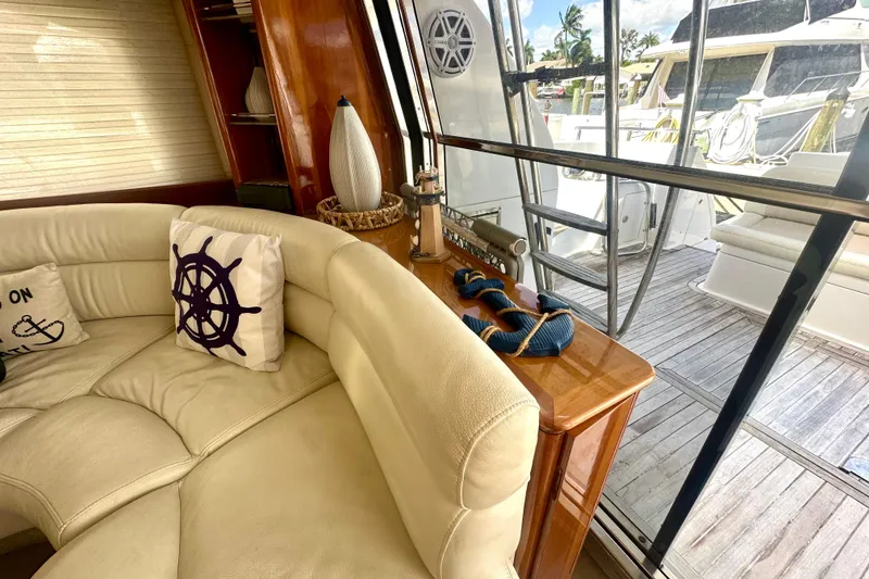 Slide: The Image of Luxurious interior of a 1999 Azimut 58 yacht with plush seating and nautical decor. - 59
