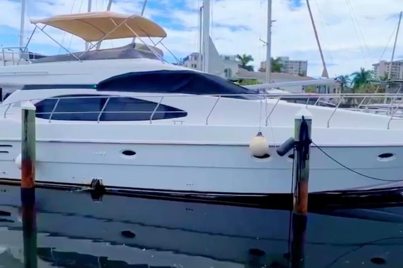 Slide: The Image of 1999 Azimut 58 yacht docked at marina, featuring sleek design and modern amenities. - 6