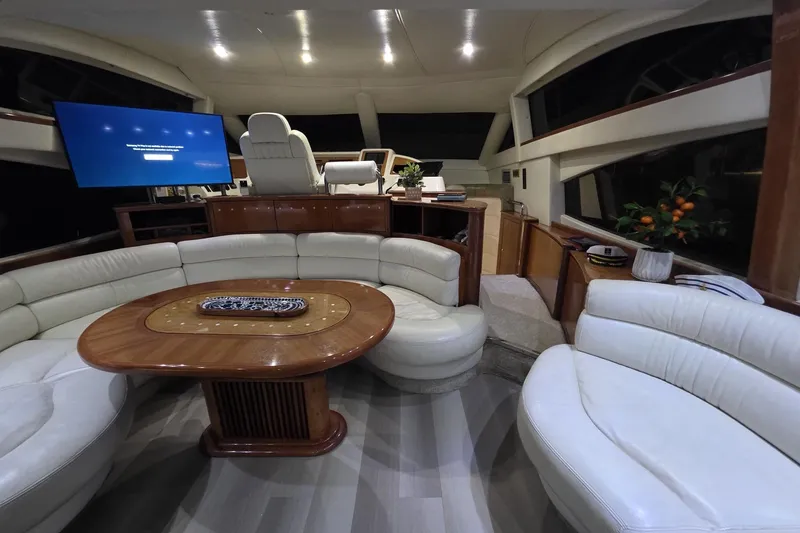 Slide: The Image of Luxurious interior of a 1999 Azimut 58 yacht with elegant seating and modern amenities. - 60