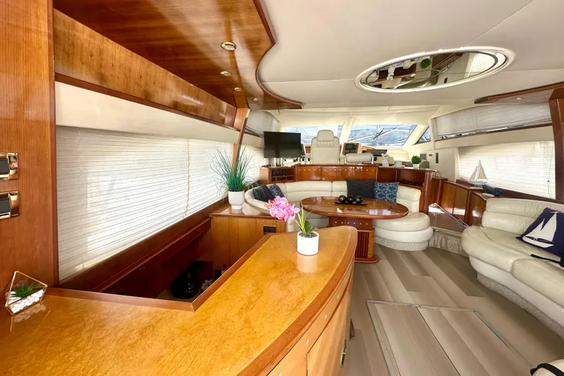 Slide: The Image of Luxurious interior of a 1999 Azimut 58 yacht with elegant wood finishes and plush seating. - 61