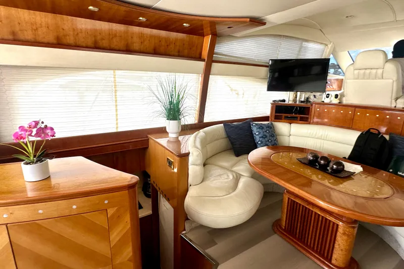 Slide: The Image of Luxurious interior of a 1999 Azimut 58 yacht with elegant wood finishes and plush seating. - 63