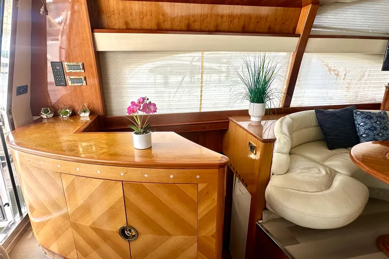 Slide: The Image of Luxurious interior of a 1999 Azimut 58 yacht with elegant wood finishes and plush seating. - 64