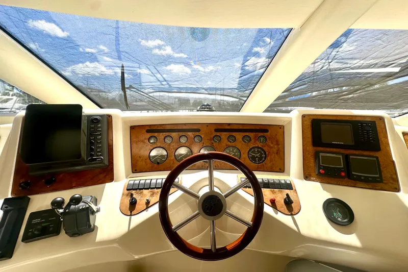 Slide: The Image of Cockpit of 1999 Azimut 58 yacht with steering wheel and navigation instruments. - 66