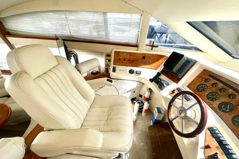 Slide: The Image of Luxurious 1999 Azimut 58 yacht cockpit with leather seating and advanced navigation controls. - 67