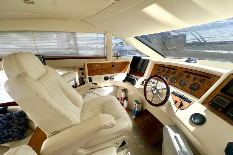 Slide: The Image of Luxurious interior of a 1999 Azimut 58 yacht cockpit with leather seating and navigation instruments. - 68