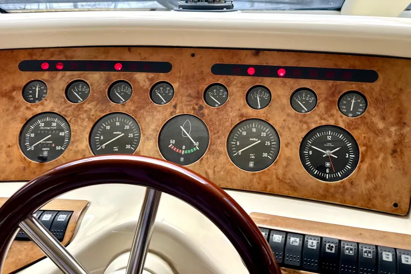 Slide: The Image of Dashboard of a 1999 Azimut 58 yacht with gauges and controls. - 70