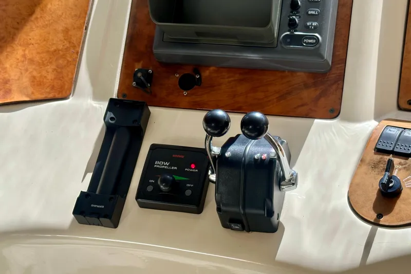 Slide: The Image of Control panel of a 1999 Azimut 58 yacht with throttle and bow propeller controls. - 72