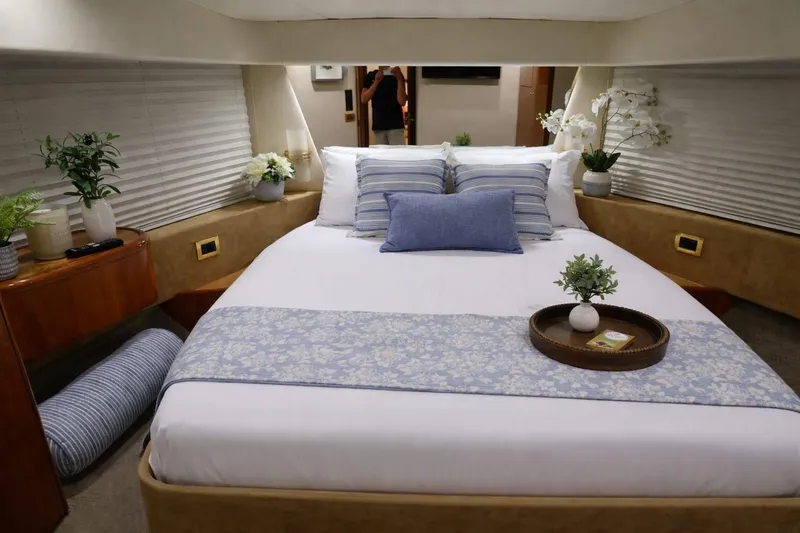 Slide: The Image of Luxurious bedroom interior of a 1999 Azimut 58 yacht with elegant decor and cozy bedding. - 73