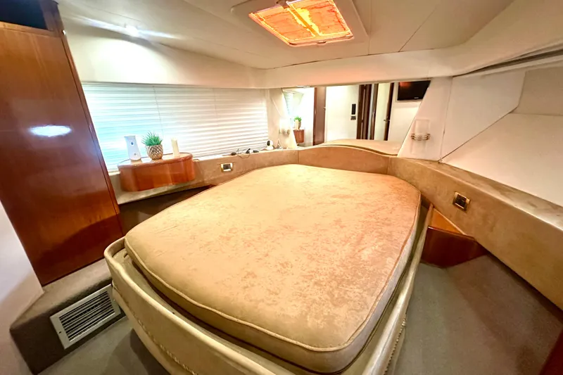 Slide: The Image of Luxurious bedroom interior of a 1999 Azimut 58 yacht with elegant furnishings. - 75