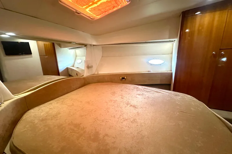 Slide: The Image of Luxurious bedroom interior of 1999 Azimut 58 yacht with elegant wood finishes. - 77