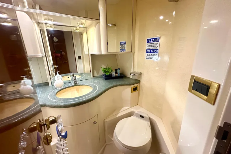 Slide: The Image of Luxurious bathroom in a 1999 Azimut 58 yacht with modern fixtures and elegant design. - 78