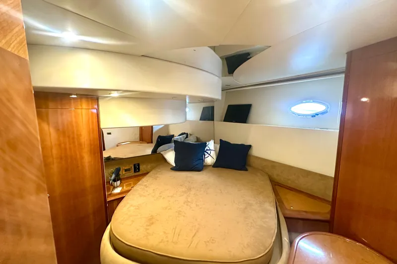 Slide: The Image of Luxurious cabin interior of a 1999 Azimut 58 yacht with elegant wood finishes. - 80