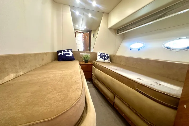Slide: The Image of Luxurious interior of a 1999 Azimut 58 yacht with beige seating and nautical decor. - 84