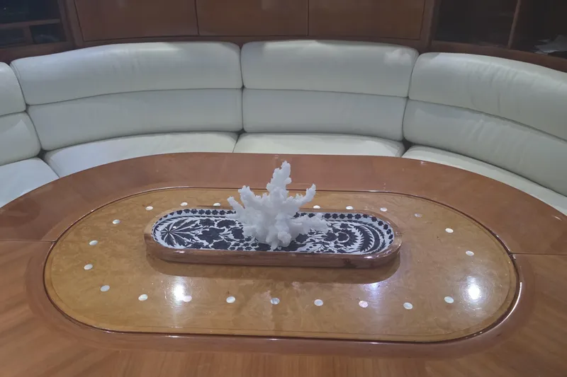 Slide: The Image of Luxurious Azimut 58 yacht interior with elegant wooden table and decorative centerpiece, 1999 model. - 87