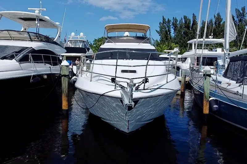 Slide: The Image of 1999 Azimut 58 yacht docked among other boats in a marina. - 9