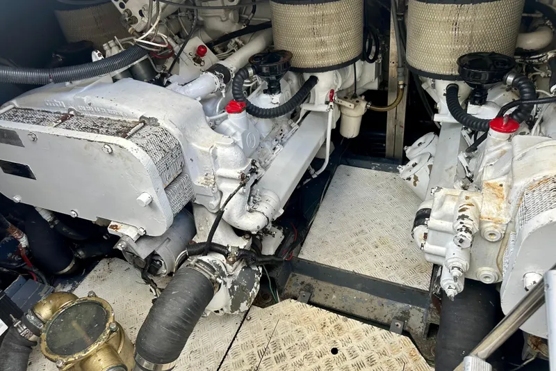 Slide: The Image of Engine room of a 1999 Azimut 58 yacht, showcasing dual engines and mechanical components. - 91