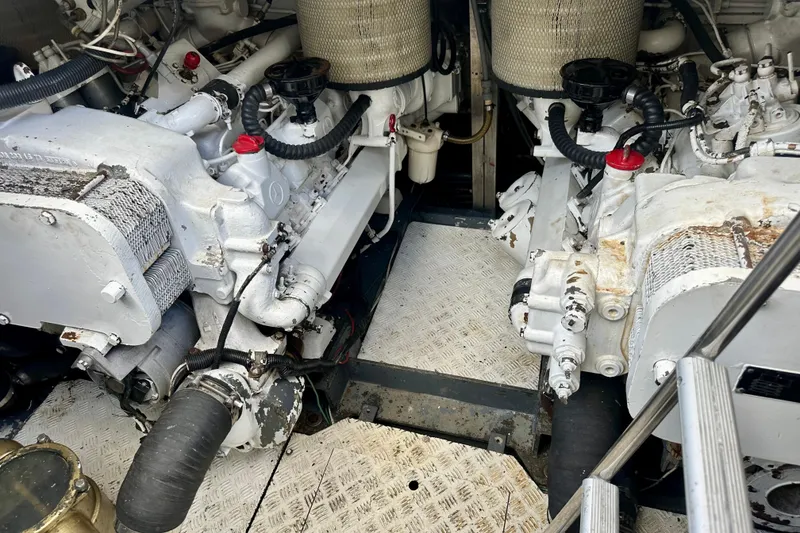Slide: The Image of Engine room of a 1999 Azimut 58 yacht, showcasing dual engines and mechanical components. - 92
