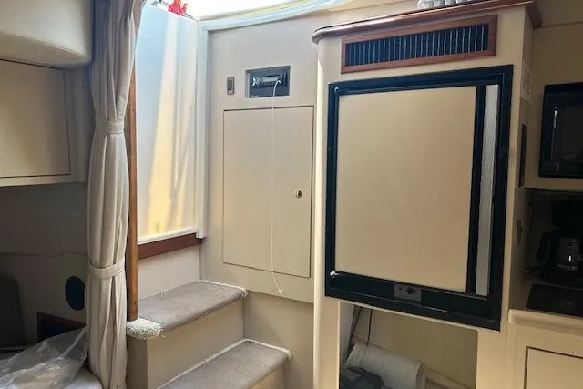 Slide: The Image of Interior of 2000 Cruisers 3575 yacht with steps, fridge, and curtain. - 11