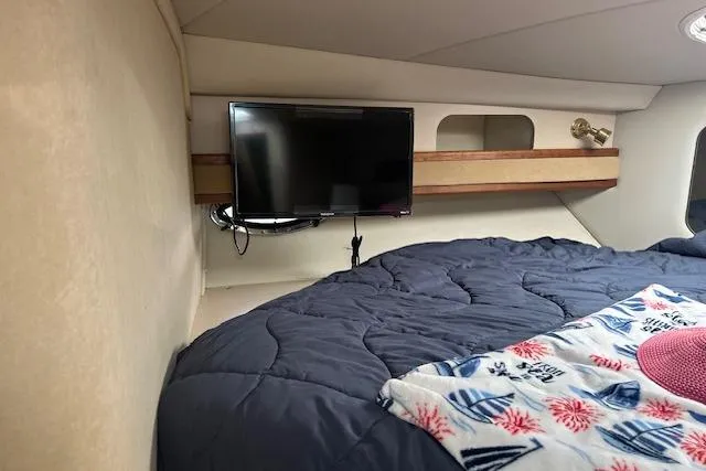 Slide: The Image of Cozy cabin interior of 2000 Cruisers 3575 with TV and bedding. - 16