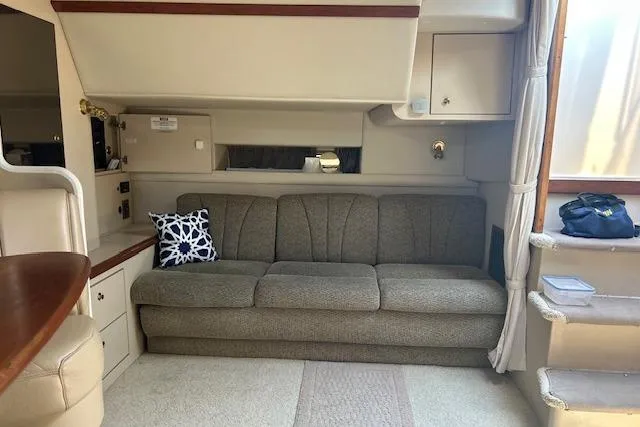 Slide: The Image of Interior of 2000 Cruisers 3575 yacht with a comfortable sofa and nautical decor. - 20