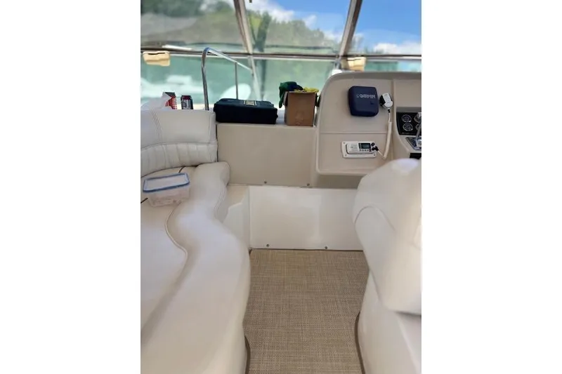 Slide: The Image of Interior of a 2000 Cruisers 3575 yacht with beige seating and navigation equipment. - 3